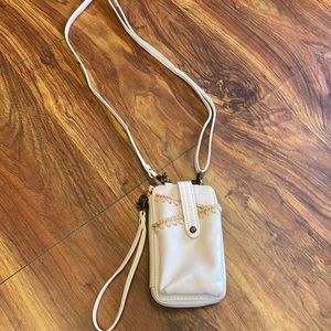 The Sak wallet and cell phone cross busy with two removable straps